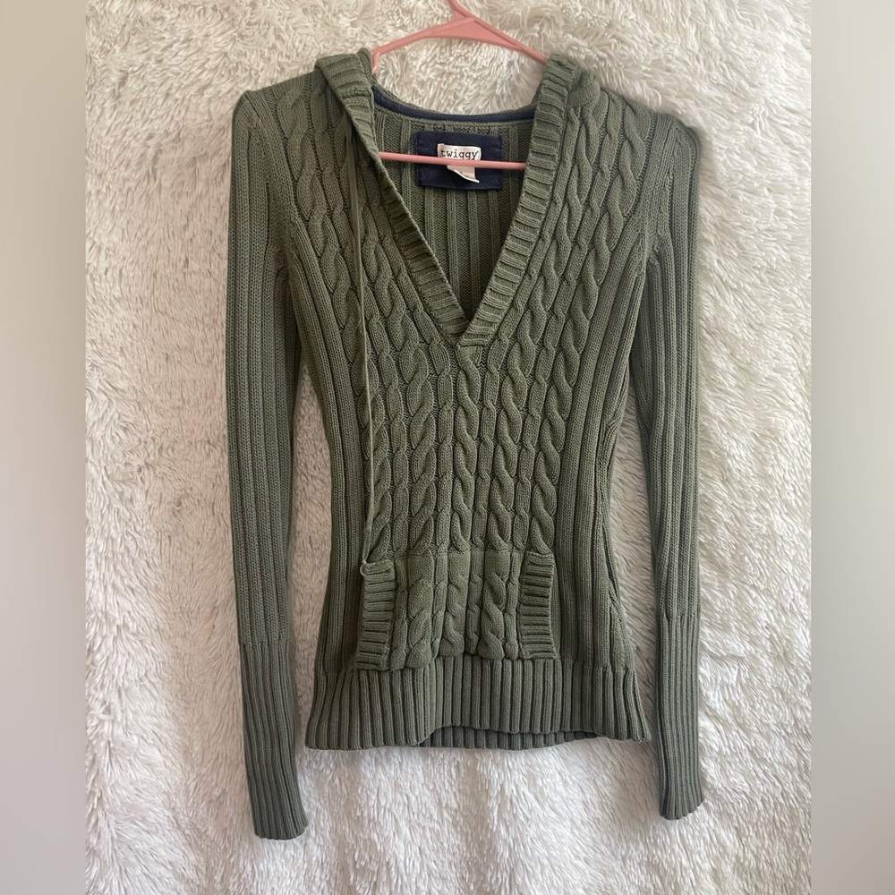 light green form fitting knit sweater with a front pocket and big hood